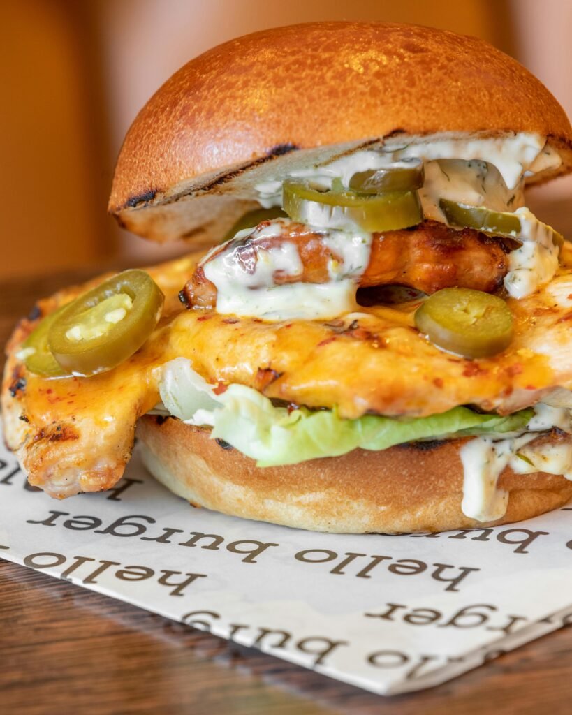 Savor this mouth-watering grilled chicken burger topped with jalapenos and cheese, perfect for spicy food lovers.